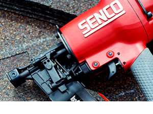 A Senco Tools Pneumatic Air Nailer laying on some shingles.